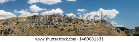 Lucan rock landscape visible from the city of Matera, features the caves carved into the rock used by the shepherds, a large image composed with the fusion of 4 individual shots.