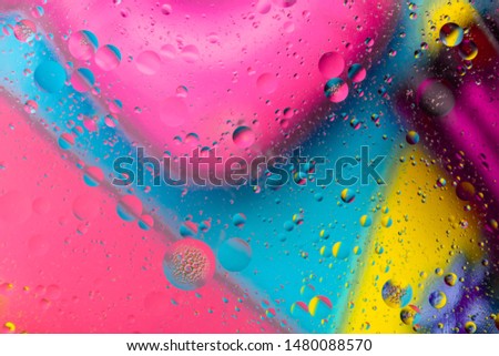 Abstract pattern of colored oil bubbles on water. Oil drops in water abstract psychedelic pattern image. 
