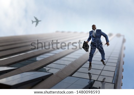 Black businessman walking on modern corporate building facades
