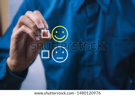 Conceptual the customer responded to the survey. The client using digital pen checkbox on happy face smile icon. Depicts that customer is very satisfied. Service experience and satisfaction concept. Royalty-Free Stock Photo #1480120976