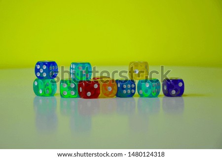 Colourful dices in yellow and white backgrounds