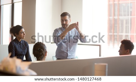 In modern shared space gather together businesspeople diverse employees listen ceo company boss executive give speech explain to staff corporate goals search solutions together during briefing concept Royalty-Free Stock Photo #1480127468