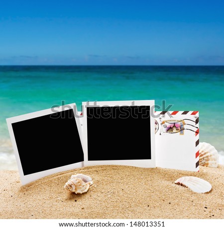 empty photo frame and a letter from vacation in the sand