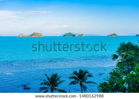 Beautiful outdoor beach sea ocean with coconut palm and other tree around island for travel in holiday vacation concept