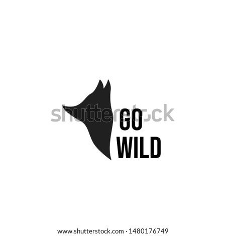 Isolated black wolf silhouette logo with text GO WILD on white background. Hand-drawn simple animal emblem for nature company business. Suitable for a t-shirt and other apparel, tattoo design