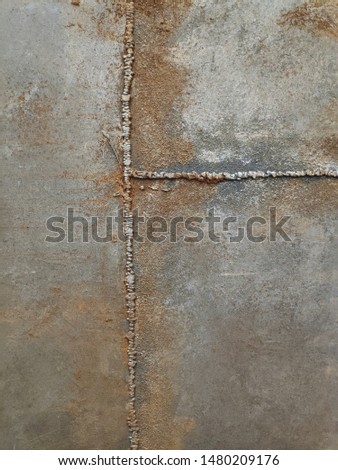 Texture of decorative plaster in shades of gray, blue, rusty color. Medium and large texture, elements of large relief, rust imitation. Loft style wall decoration option.