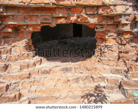 Big hole in the brickwork. Concrete.                              