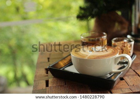 Cappuccino Coffee, coffee mugs and accessories in coffee shops garden background copy space