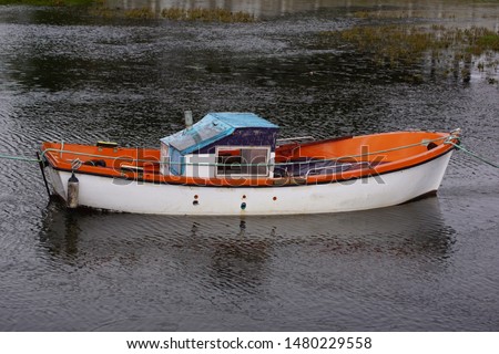 Small fishing boat anchored in the marshes of the Miñor River in Pontevedra (Galicia)