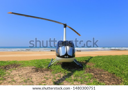White helicopter on the beach