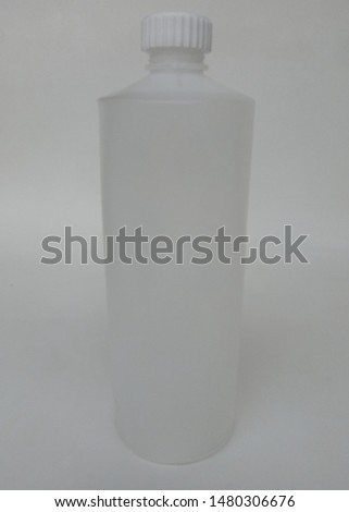 a white canister bottle with a threaded texture lid on a white background