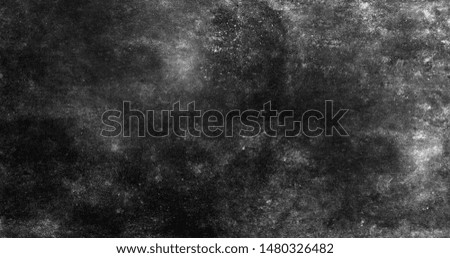 The dirty rough concrete wall is covered with black spots with a textured surface .Texture or background