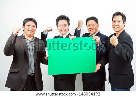 Team of Businessmen holding a blank green banner