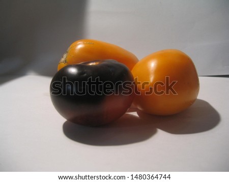 yellow tomatoes and brown on a white background, products from the farmer