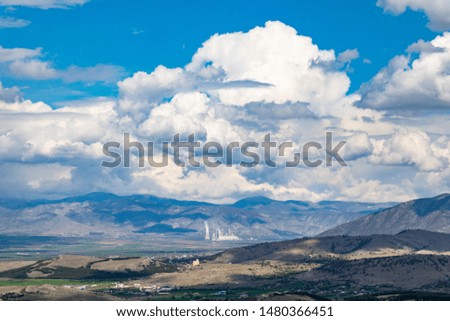 White clouds hanging from blue sky for backdrop. Scattered clouds on daylight, skyline from under view, banner.