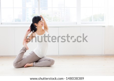 attractive asian woman exercising in the room Royalty-Free Stock Photo #148038389