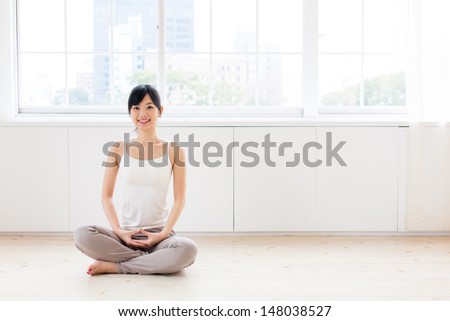 attractive asian woman exercising in the room