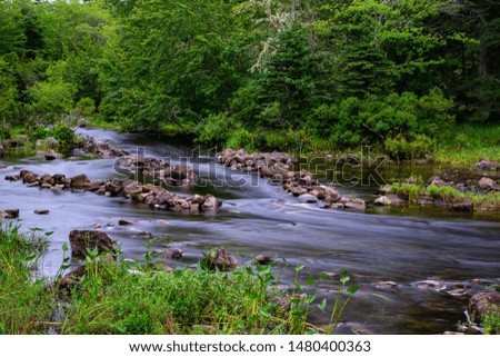 Scenic nature reserve in Yarmouth County, Nova Scotia, Canada. Long exposure river shot, showing a man made rock system to allow kayaks (fish) to swim upstream and also made them easier to catch.