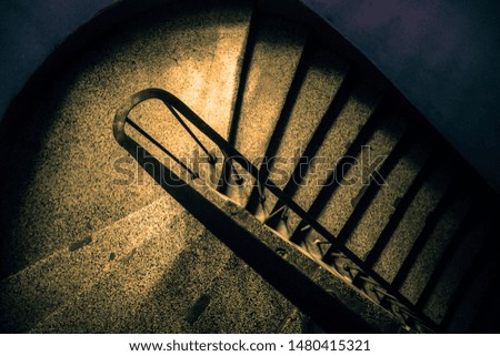 Vintage spiral staircase. Retro vintage aged staircase. Top view of the rounded stairs in the old vintage building. Abstract concept. Copy space. Vintage effect. 