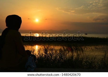 romantic sunset on the lake shore
