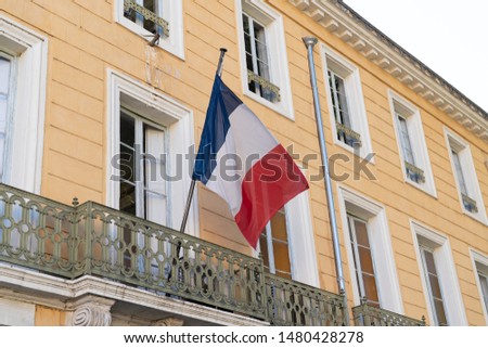 french facade building with the national flags of France