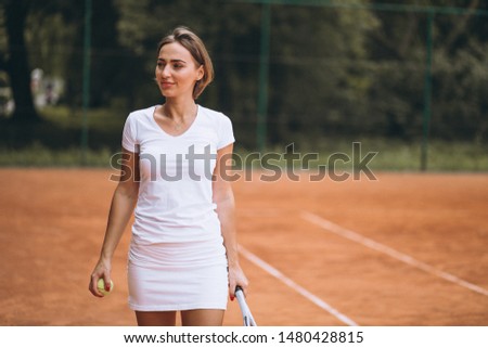 Young woman tennis player at the court