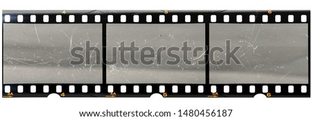 original 35mm filmstrip with empty dusty frames or cells and nice texture on the border, fluffs on film material, real film grain Royalty-Free Stock Photo #1480456187