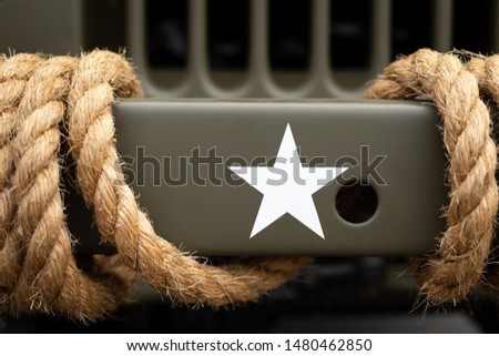 Close up on a white American Infantry Star on the bumper of a vintage army vehicle, in an armed services concept