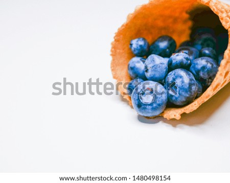 Blueberry Ice Cream. on a white background. blueberries pour from the horn. ice cream isolated on white background