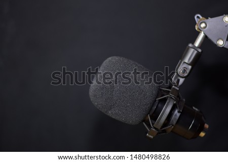 Close-up of retro microphone isolated on bokeh black background