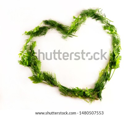 Heart frame. Green diet food. Dill and parsley. Isolated photo.