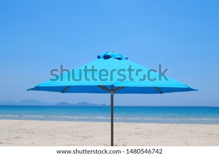 Beach umbrella on a beautiful sandy beach. panorama of a tropical beach with white sand and turquoise water.  Travel and leisure concept. Tourist background. Screensaver on your computer.