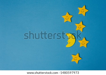 Crescent moon and yellow stars against the blue night sky. Application paper . Copy space