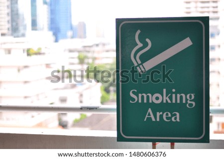 The smoking area sign in green color in car park