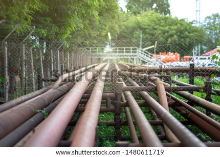 Crude oil and gas pipeline which is used to transfer petroleum from well site to process station. A part of pipeline in photo is located at public road side . Selected focus at some point on the pipe.