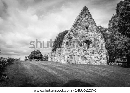 a church ruin with clouds in the background