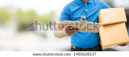 Delivery man holding cardboard boxes / copy space Royalty-Free Stock Photo #1480628237
