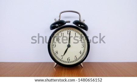 vintage alarm clock against background