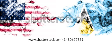 United States of America vs Saint Lucia smoky mystic flags placed side by side. Thick colored silky abstract smokes banner of America and Saint Lucia