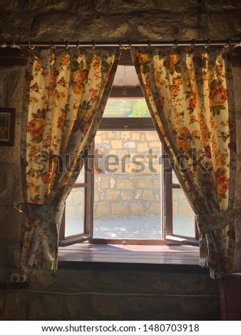 old tapestry  goblin curtain, village house, window and reflection of amazing evening sunlight Royalty-Free Stock Photo #1480703918