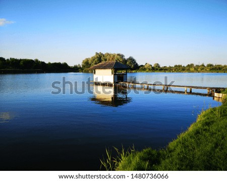 Wooden Gazebo on summer lake