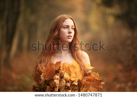 Close up portrait of beautiful red haired Woman, Fall Leaves Dress, Beauty Girl in the autumn park