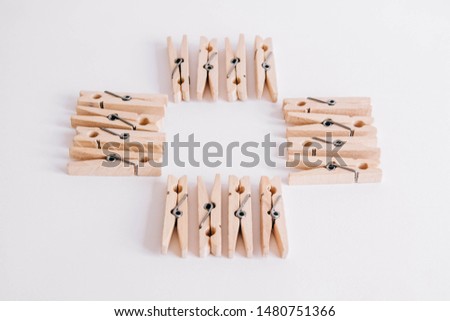 Wooden clothespins on a white background. View from above. Place for your text