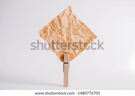 Brown sticker with wooden clothespin isolated on white background. Place for your text