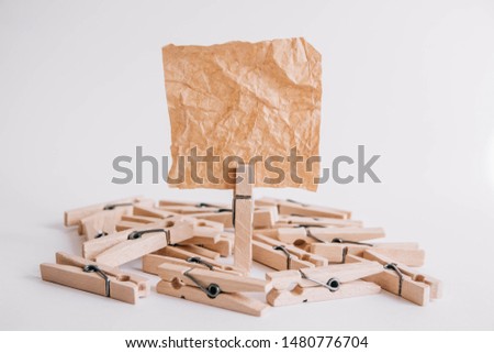 Woodenl clothespins, paper clip and brown sticker on white background. Isolated on white. Place for your text