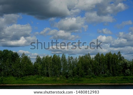River Daugava near the city Jekabpils sunny summer day.
white cloud in the blue sky                