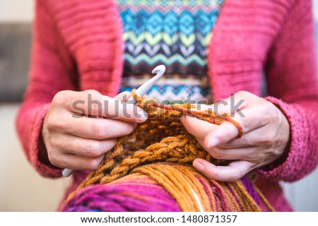 Woman crochets. Handwork. Crochet hook. Female hands closeup. Female hands hold the hook. Vintage carpet. Knitted plaid. Handmade. Home hobby. Royalty-Free Stock Photo #1480871357
