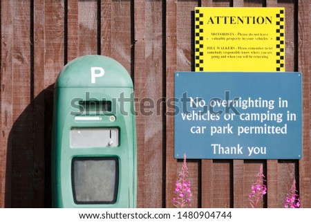 Parking pay machine and no overnight camping sign