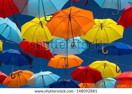 Lots of umbrellas coloring the sky in the city of Agueda, Portugal Royalty-Free Stock Photo #148092881