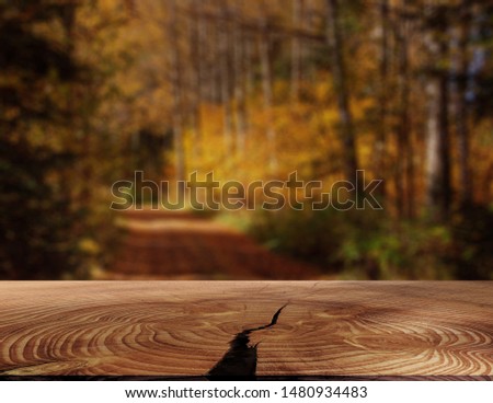 Wood table top on blur abstract natural foliage bokeh background, vintage tone - can be used for display or montage your products